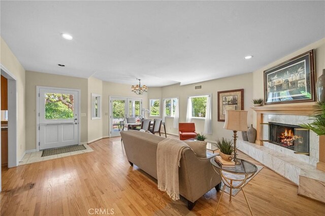 5894 E Appian Way, Long Beach, CA 90803 - living area featuring light wood-style flooring, a chandelier, a tile fireplace, recessed lighting, and baseboards