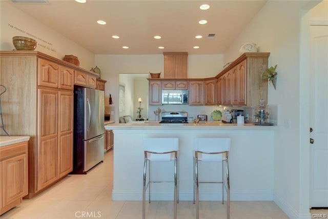 4451 Casa Sierra, Paradise, CA 95969 - kitchen featuring stainless steel appliances, recessed lighting, a peninsula, light countertops, and light tile patterned floors