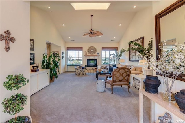 4451 Casa Sierra, Paradise, CA 95969 - carpeted living area featuring high vaulted ceiling, a skylight, a ceiling fan, a glass covered fireplace, and recessed lighting