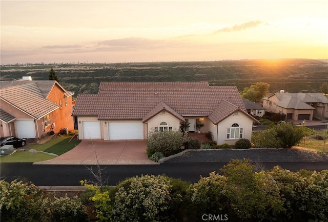 4451 Casa Sierra, Paradise, CA 95969 - view of front facade featuring a tile roof, driveway, a garage, and stucco siding