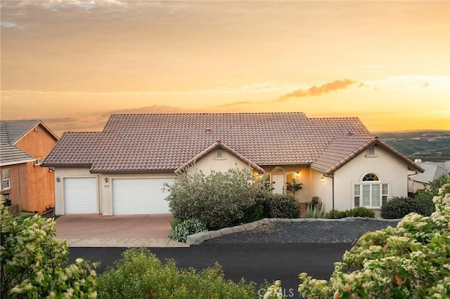 4451 Casa Sierra, Paradise, CA 95969 - mediterranean / spanish house with stucco siding, a garage, a tile roof, and concrete driveway
