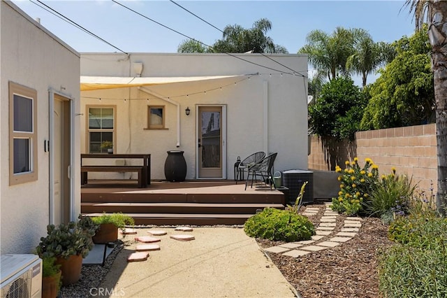 6062 Gaviota Ave, Long Beach, CA 90805 - back of house featuring fence, central AC unit, stucco siding, and a deck