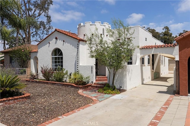 6062 Gaviota Ave, Long Beach, CA 90805 - mediterranean / spanish house with stucco siding, a tile roof, driveway, fence, and a carport