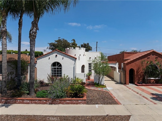 6062 Gaviota Ave, Long Beach, CA 90805 - mediterranean / spanish-style house with stucco siding, fence, and concrete driveway