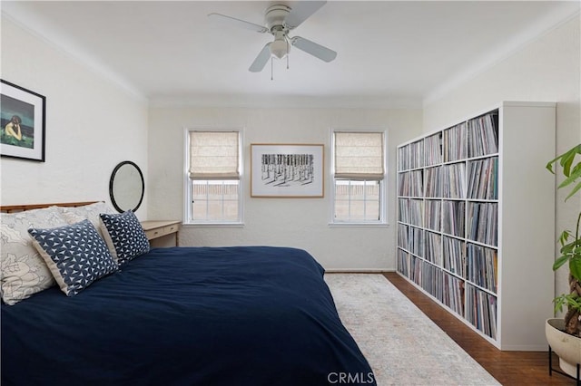 6062 Gaviota Ave, Long Beach, CA 90805 - bedroom with multiple windows, crown molding, wood finished floors, a ceiling fan, and baseboards