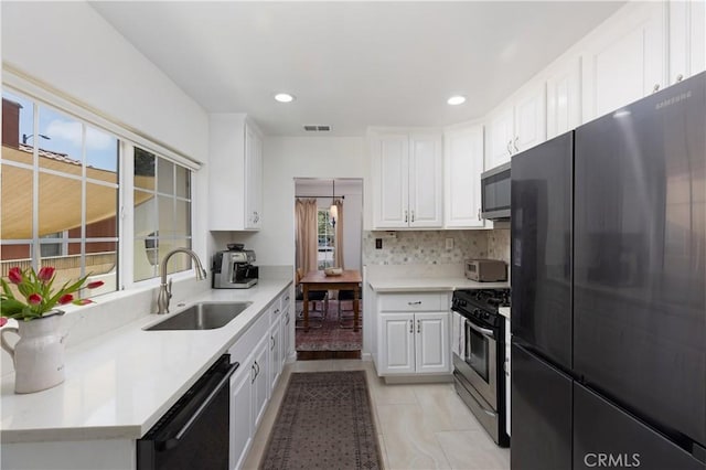 6062 Gaviota Ave, Long Beach, CA 90805 - kitchen with appliances with stainless steel finishes, a sink, white cabinets, decorative backsplash, and light countertops