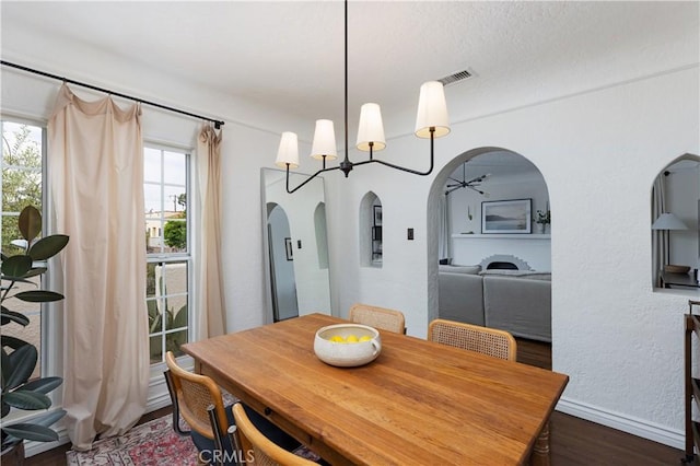 6062 Gaviota Ave, Long Beach, CA 90805 - dining room featuring arched walkways, wood finished floors, and healthy amount of natural light
