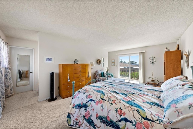 bedroom with carpet floors, access to exterior, and a textured ceiling