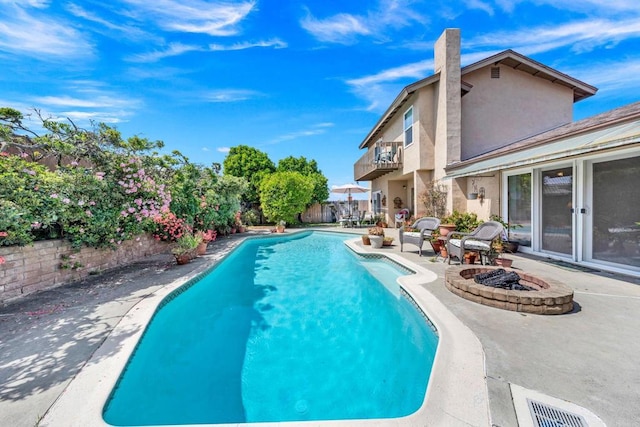view of pool with an outdoor fire pit, a patio area, and a fenced backyard