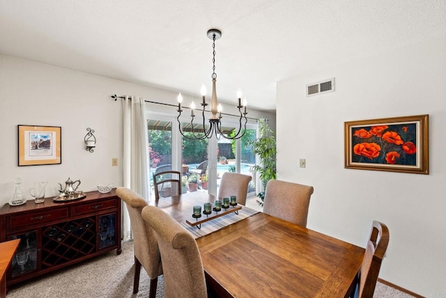 dining area featuring light carpet, a chandelier, and plenty of natural light