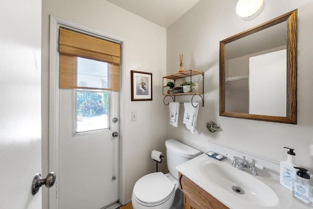 bathroom featuring toilet and vanity
