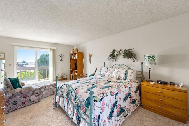 bedroom featuring carpet floors, access to exterior, and a textured ceiling