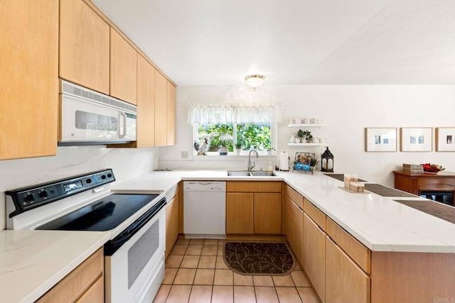 kitchen featuring white appliances, a sink, a peninsula, light tile patterned floors, and open shelves