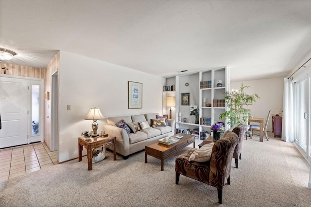 living area featuring light colored carpet and light tile patterned floors