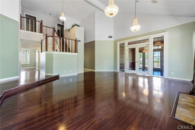 16350 Ridge View Dr, Apple Valley, CA 92307 - unfurnished living room with high vaulted ceiling, baseboards, wood finished floors, and french doors