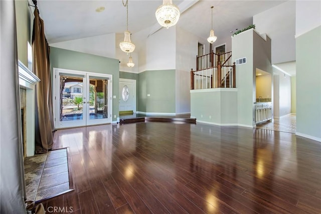 16350 Ridge View Dr, Apple Valley, CA 92307 - unfurnished living room with high vaulted ceiling, wood finished floors, a chandelier, french doors, and baseboards