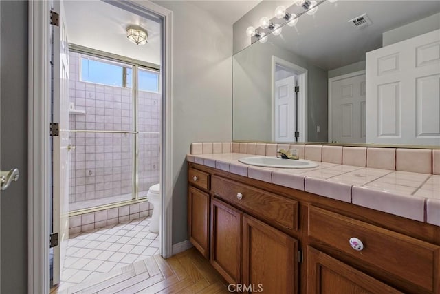 16350 Ridge View Dr, Apple Valley, CA 92307 - bathroom with a stall shower, toilet, and vanity
