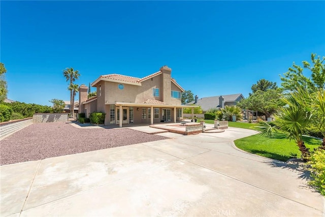 16350 Ridge View Dr, Apple Valley, CA 92307 - rear view of property featuring stucco siding, a tile roof, a chimney, a patio, and fence