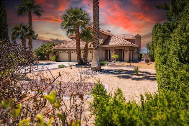 16350 Ridge View Dr, Apple Valley, CA 92307 - mediterranean / spanish-style house with stucco siding, driveway, a garage, and a tiled roof