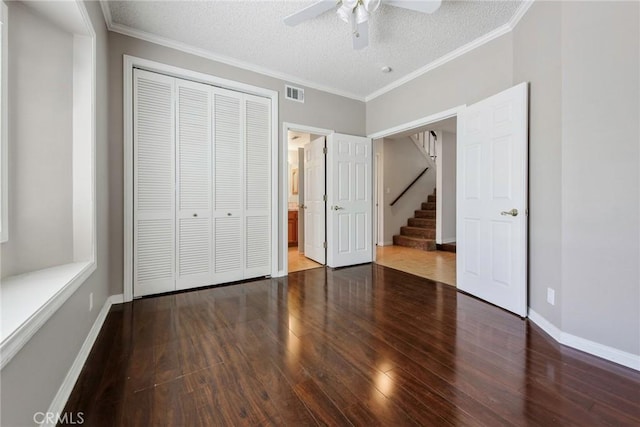 16350 Ridge View Dr, Apple Valley, CA 92307 - unfurnished bedroom with wood finished floors, a closet, baseboards, crown molding, and a textured ceiling