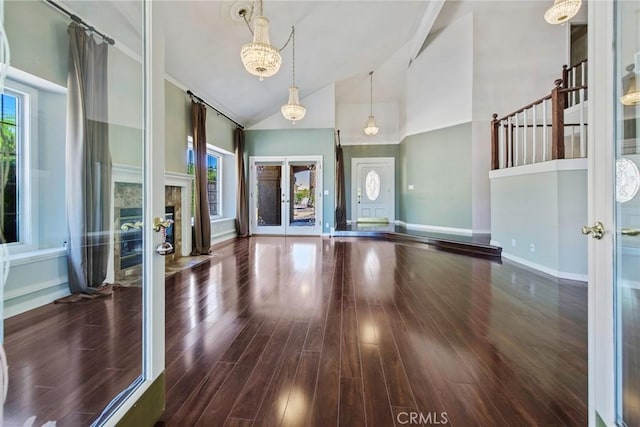 16350 Ridge View Dr, Apple Valley, CA 92307 - unfurnished living room featuring high vaulted ceiling, wood finished floors, baseboards, and french doors