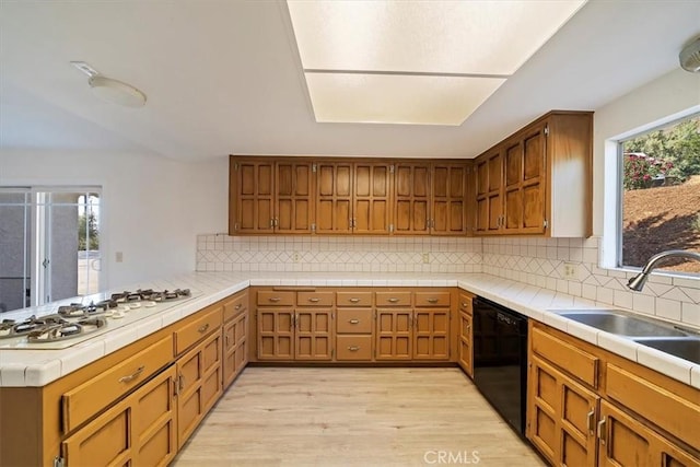 4180 Mount Baldy Ct, Norco, CA 92860 - kitchen with dishwasher, a peninsula, white gas cooktop, light wood-style flooring, and tile countertops