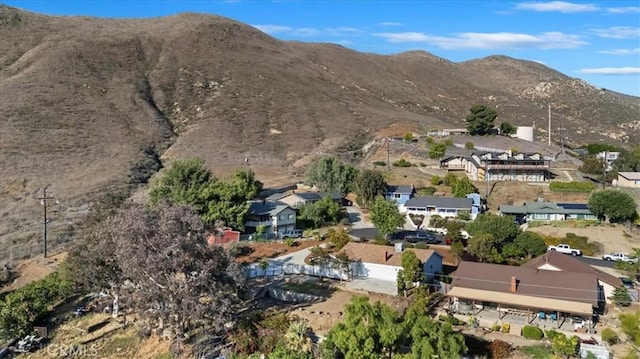 4180 Mount Baldy Ct, Norco, CA 92860 - aerial view of property and surrounding area featuring a mountain backdrop and nearby suburban area