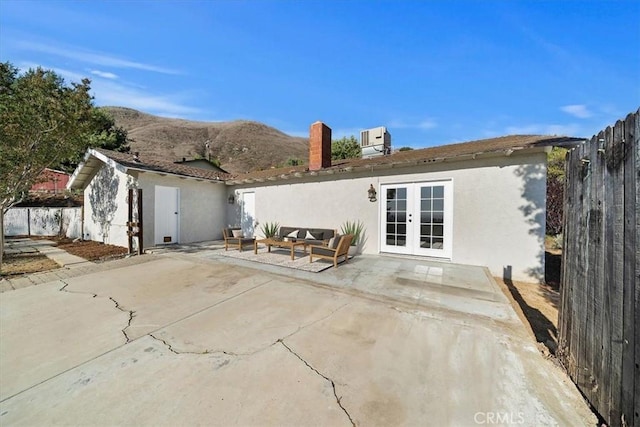 4180 Mount Baldy Ct, Norco, CA 92860 - rear view of house with french doors, a patio, stucco siding, central AC unit, and fence