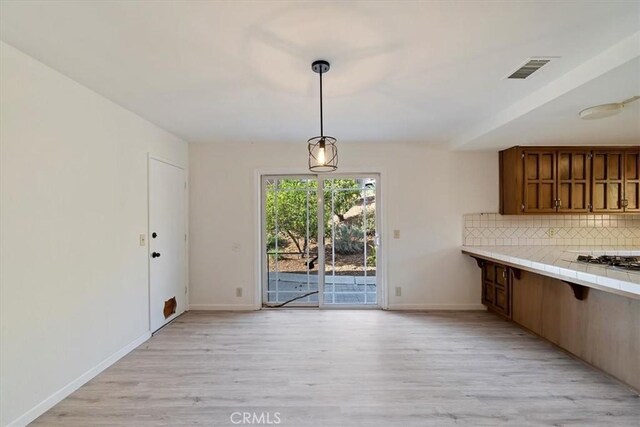 4180 Mount Baldy Ct, Norco, CA 92860 - unfurnished dining area with light wood finished floors and baseboards