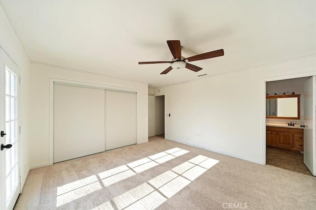 4180 Mount Baldy Ct, Norco, CA 92860 - unfurnished bedroom featuring light colored carpet, a closet, ensuite bathroom, ceiling fan, and a sink