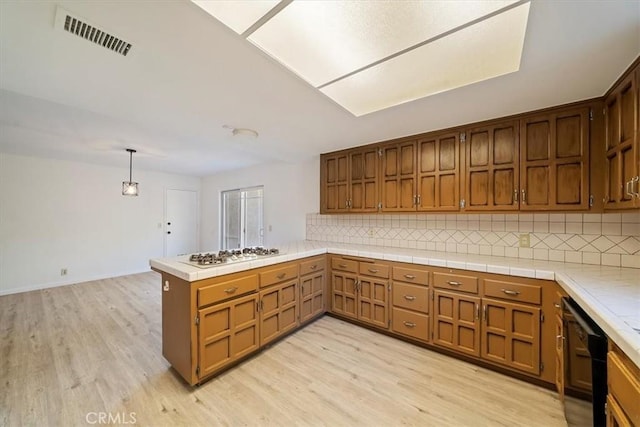 4180 Mount Baldy Ct, Norco, CA 92860 - kitchen with white gas cooktop, light wood-style floors, and backsplash