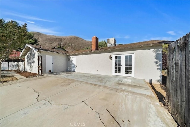 4180 Mount Baldy Ct, Norco, CA 92860 - rear view of property with french doors, a patio, fence, stucco siding, and central AC unit