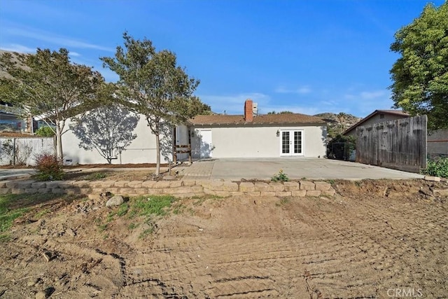 4180 Mount Baldy Ct, Norco, CA 92860 - rear view of property with french doors, a patio, fence, and a chimney