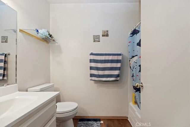 full bath with toilet, vanity, and wood finished floors