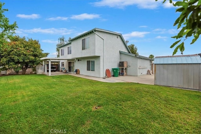 rear view of property featuring a patio, a storage unit, an outdoor structure, and a yard
