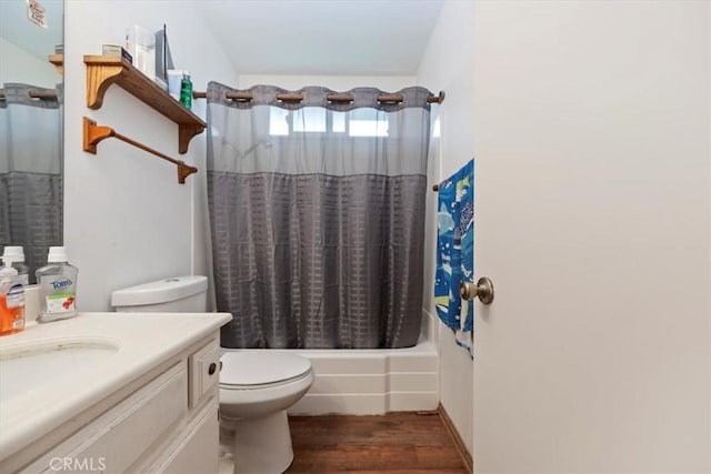 bathroom with wood finished floors, toilet, shower / tub combo with curtain, and vanity