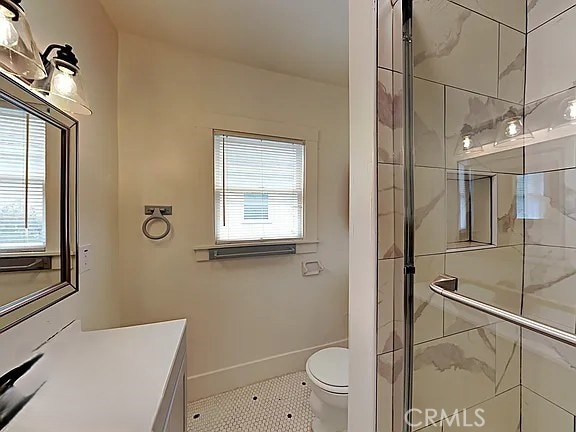 4890 7th Ave, Sacramento, CA 95820 - bathroom with a stall shower, vanity, toilet, tile patterned floors, and baseboards