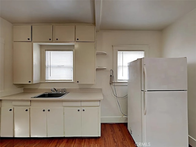 4890 7th Ave, Sacramento, CA 95820 - kitchen with freestanding refrigerator, dark wood-type flooring, light countertops, and a sink