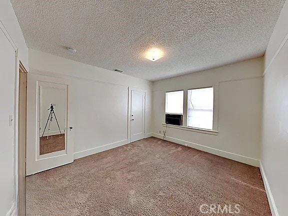 4890 7th Ave, Sacramento, CA 95820 - unfurnished room with a textured ceiling, carpet, and baseboards