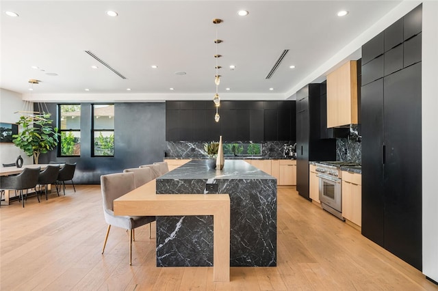 5141 Varna Ave, Sherman Oaks, CA 91423 - kitchen featuring stainless steel range, modern cabinets, dark cabinetry, backsplash, and recessed lighting