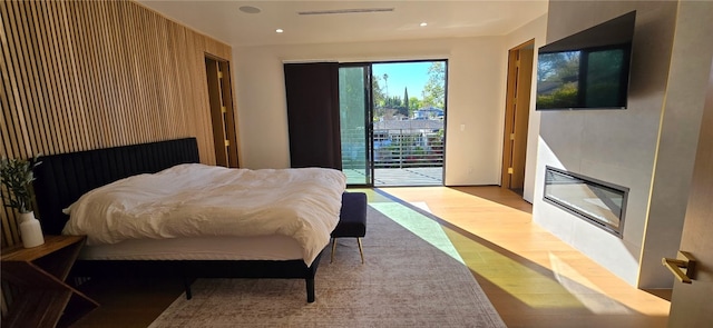5141 Varna Ave, Sherman Oaks, CA 91423 - bedroom with access to exterior, wood finished floors, recessed lighting, and a glass covered fireplace