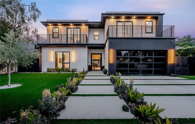 5141 Varna Ave, Sherman Oaks, CA 91423 - contemporary house featuring a balcony, driveway, stucco siding, and an attached garage