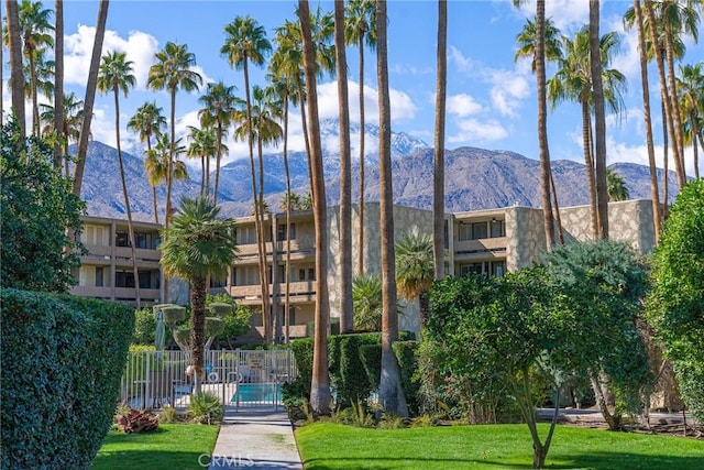 view of property with a mountain view and fence