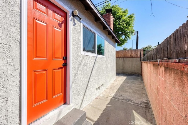 10641 Lindale St, Norwalk, CA 90650 - entrance to property featuring fence, stucco siding, a chimney, and crawl space