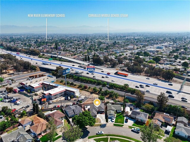 10641 Lindale St, Norwalk, CA 90650 - aerial perspective of suburban area with a main thoroughfare and a mountain backdrop