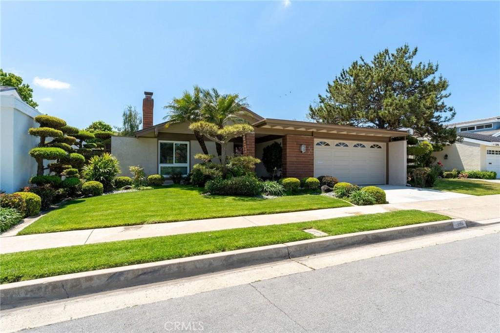 6252 Sierra Palos Rd, Irvine, CA 92603 - view of front of property with an attached garage, concrete driveway, a front yard, a chimney, and stucco siding