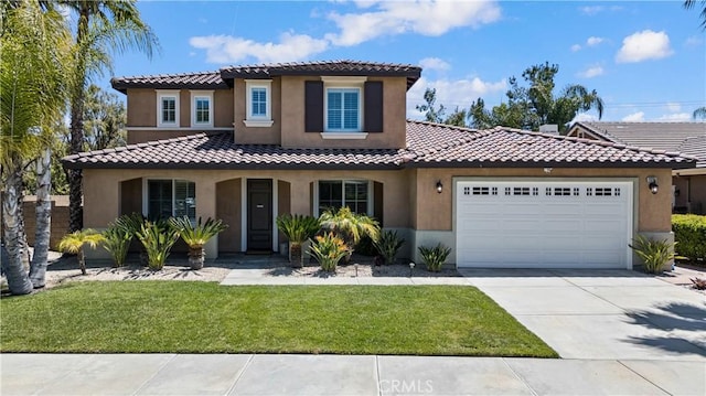 mediterranean / spanish house with stucco siding, an attached garage, a tiled roof, driveway, and a front lawn