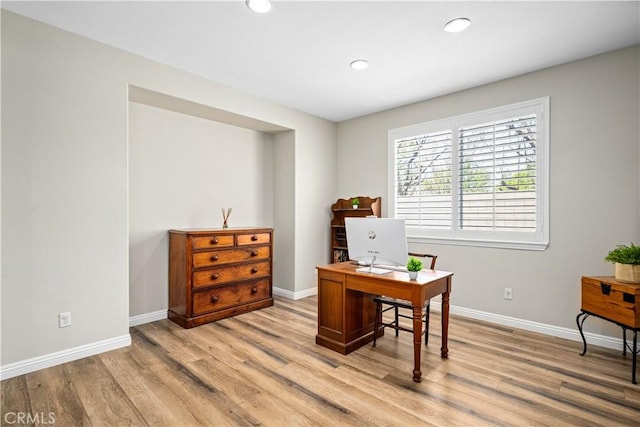 home office featuring light wood finished floors, baseboards, and recessed lighting