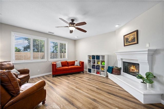 28264 Spring Creek Way, Menifee, CA 92585 - living area with ceiling fan, wood finished floors, a glass covered fireplace, baseboards, and recessed lighting