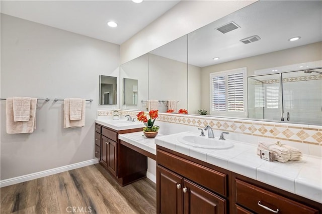 28264 Spring Creek Way, Menifee, CA 92585 - full bath with double vanity, wood finished floors, backsplash, a shower stall, and baseboards